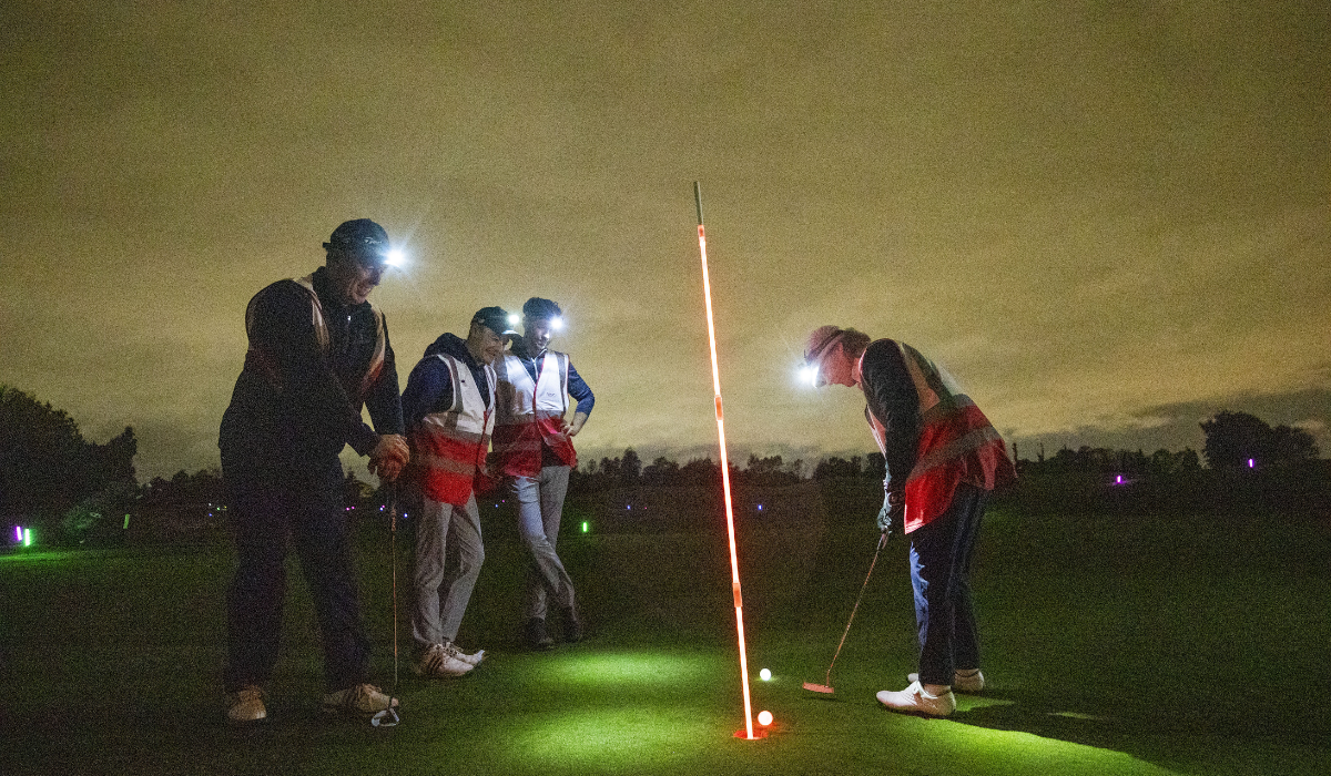 Golfers Playing Night Golf