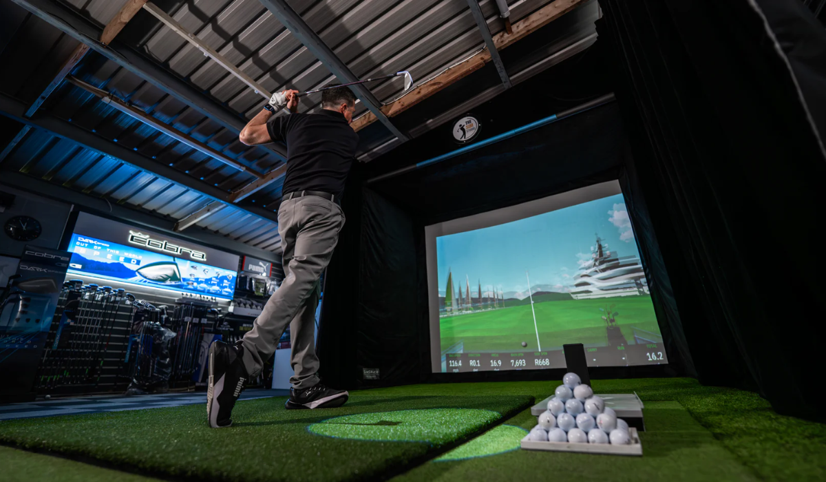 The Best Golf Simulators of 2025: Elevating Home and Professional Play A golfer hitting into a high-tech indoor simulator setup