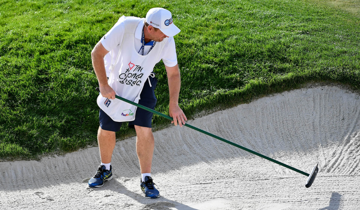 Caddie Raking a Bunker